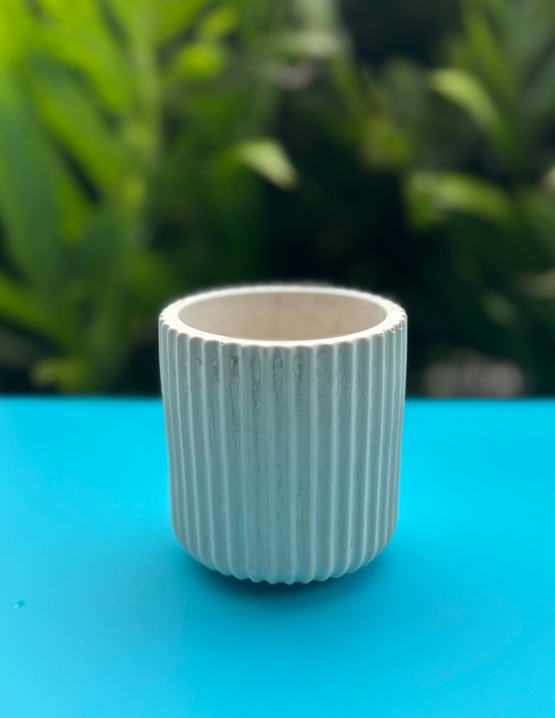 Small white concrete vase